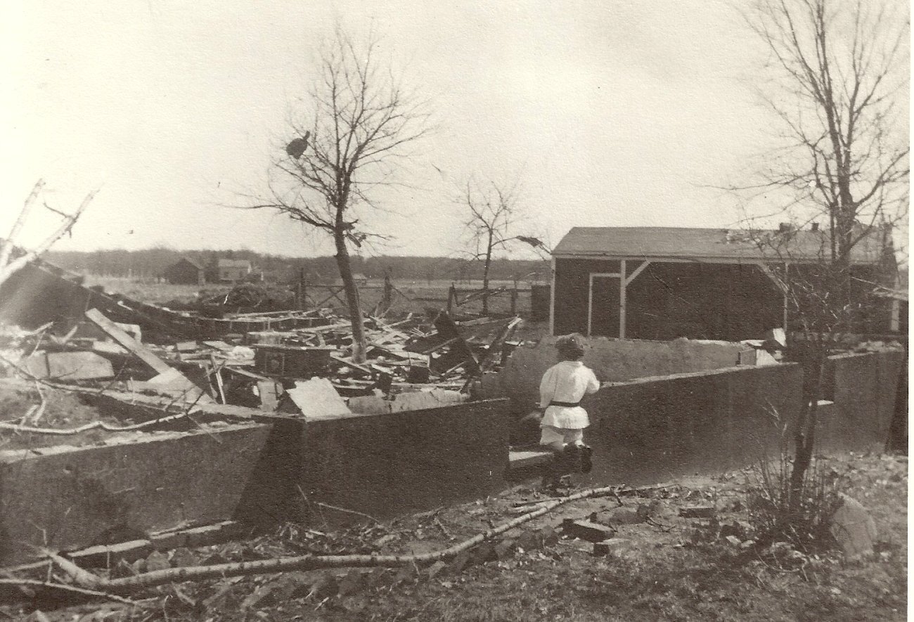 black and white photograph of a destroyed and collapsed home. A child looks at the destruction. black and white photograph of a destroyed and collapsed home. A child looks at the destruction.
