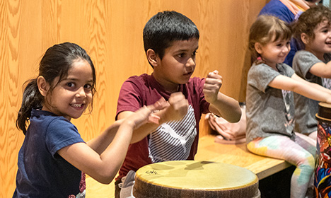 two kids playing a drum