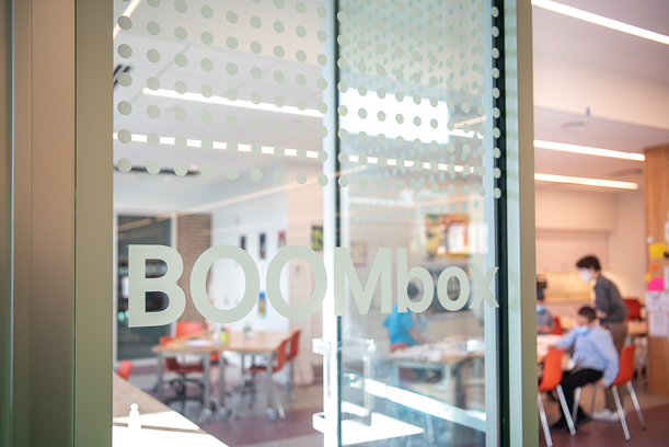 The glass outside the BOOMbox with a grid of dots and the words "BOOMbox".